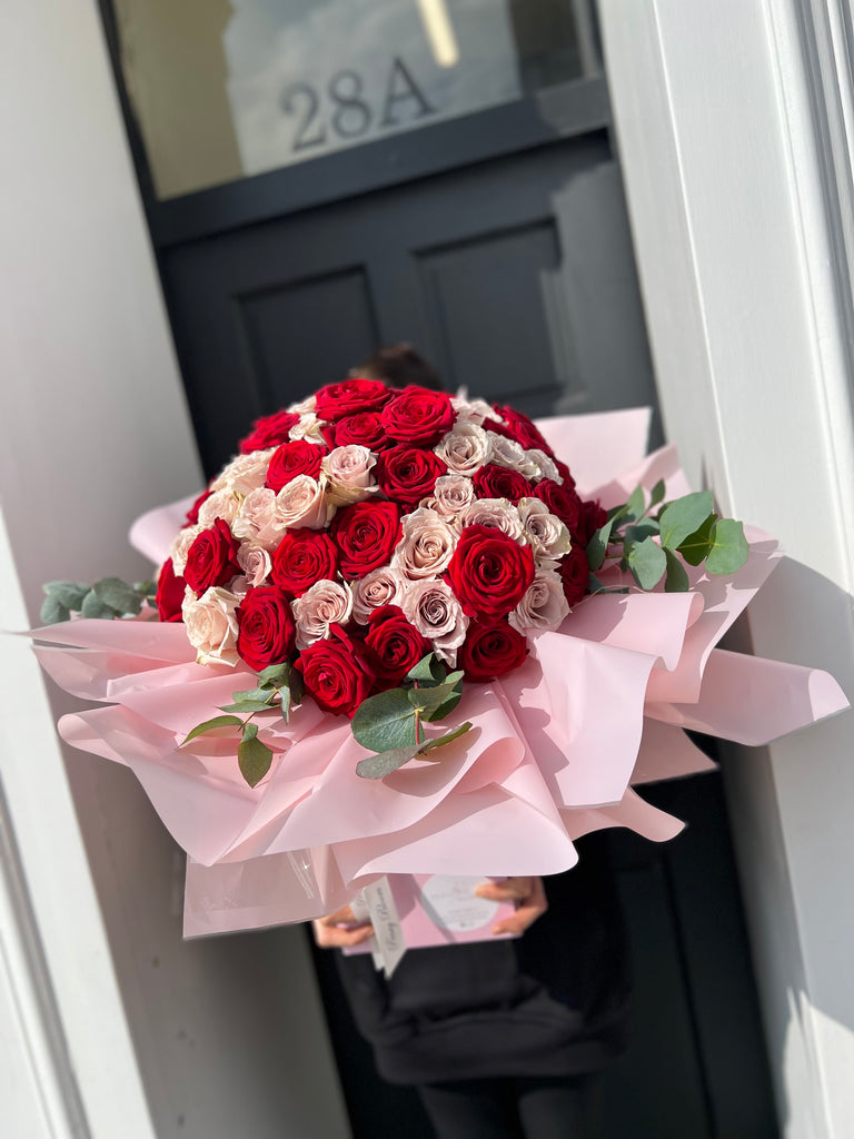mixed 50 bunch of red and pink roses with eucalytpus leaves.