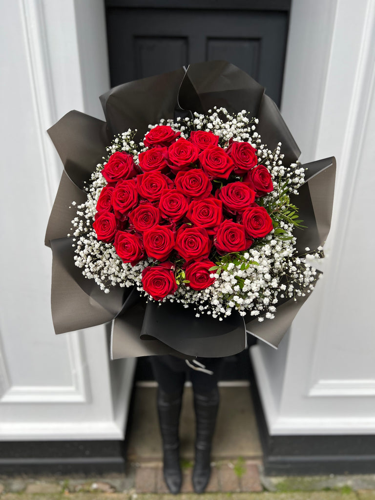 red roses bouquet surrounded by Gypsophila and other foilage