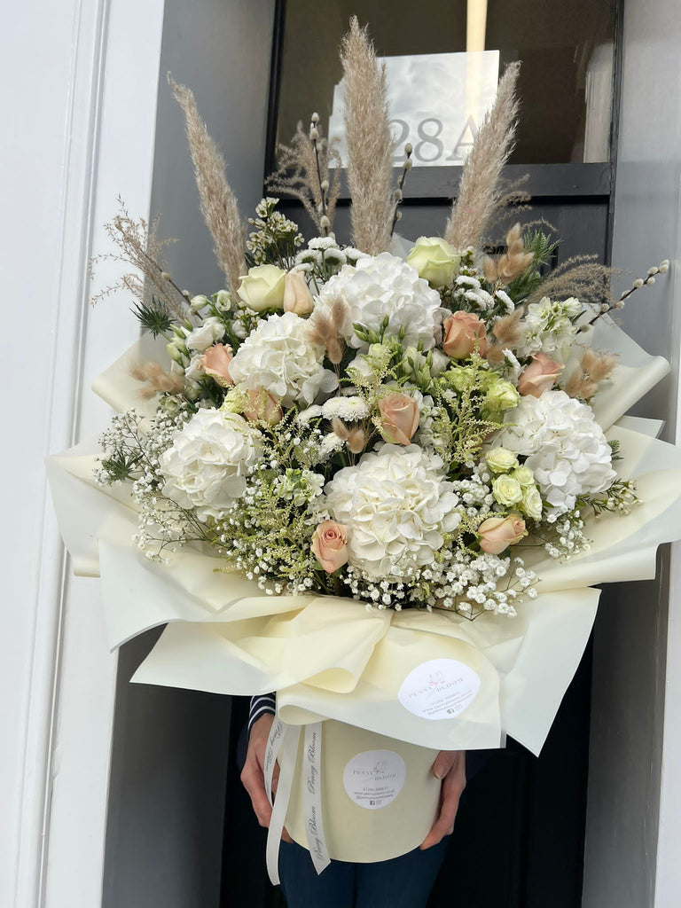 white hydrangea and nude floral bouquet with pampas grass.