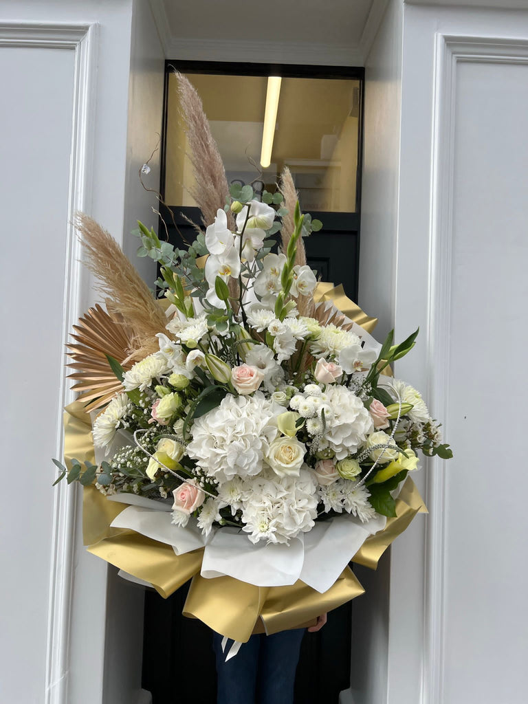 white and gold bouquet with hydrangeas roses pampas grass and orchids