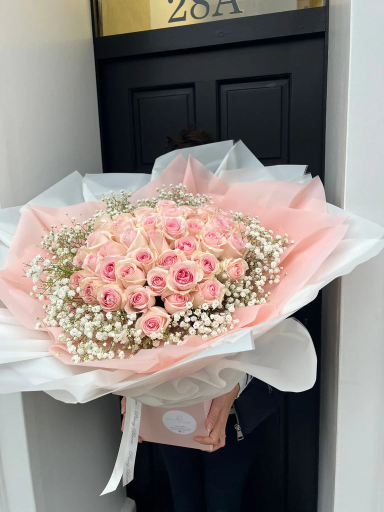 pink rose dome surrounded by gypsophillia