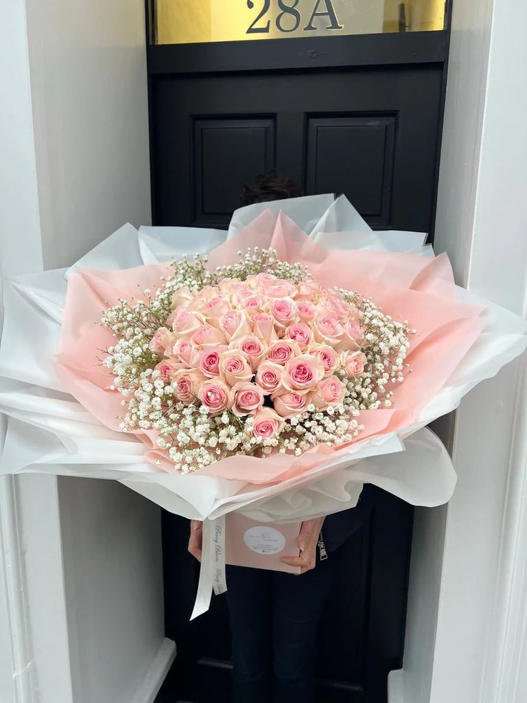 pink rose dome surrounded by gypsophillia