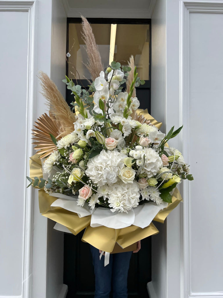 white and gold luxury bouquet with pampas grass and orchids. 