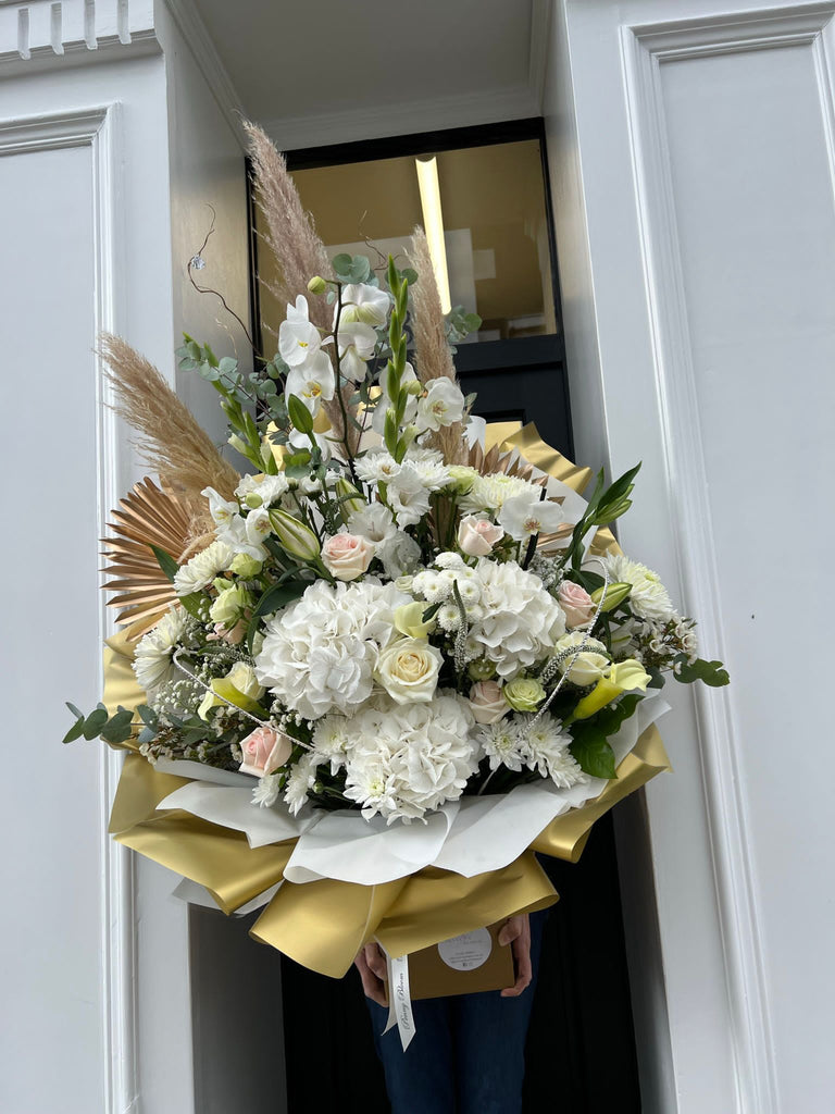 extra large white and gold flowers with hydrangeas, eucalyptus, gypsophillia, roses and lillies