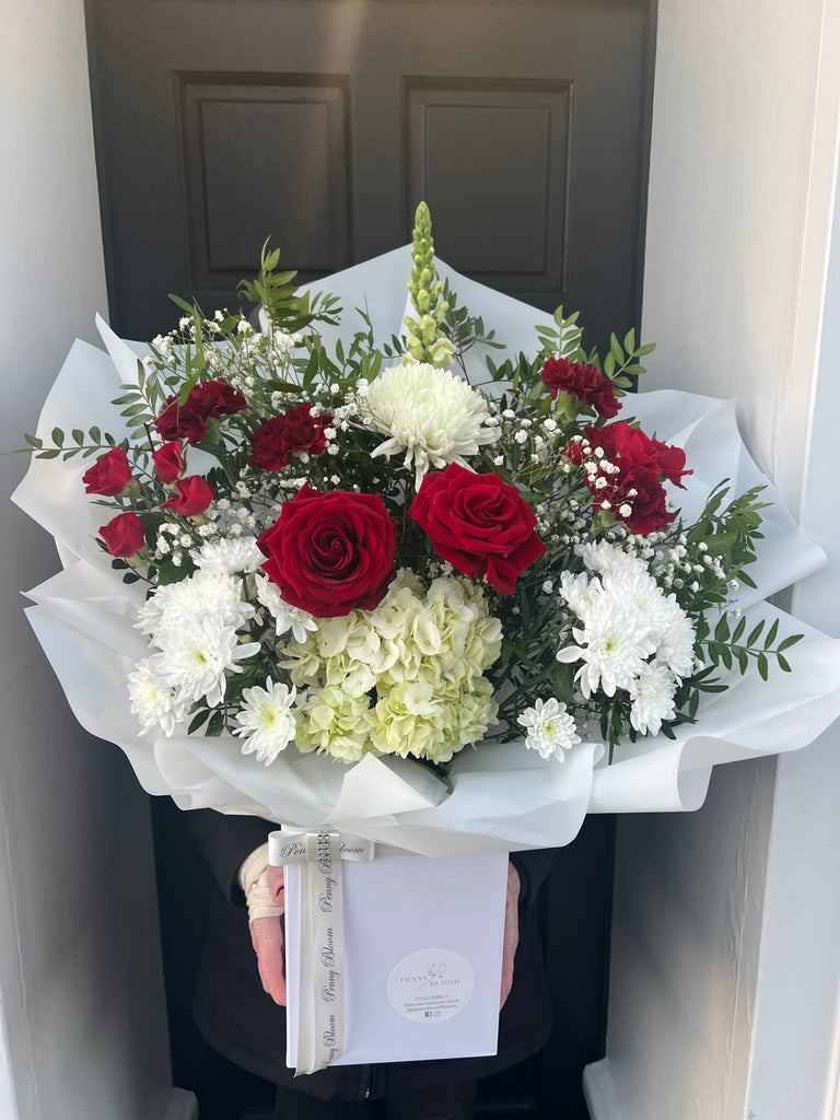 red and white smaller valentines bouquet with hydranges, roses, spray roses and gypsophillia